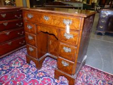 AN INLAID BURL WALNUT KNEEHOLE DESK OF EARLY GEORGIAN DESIGN WITH A MOULDED EDGE TOP ABOVE A LONG