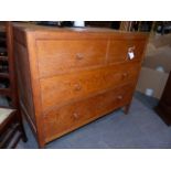 A HEAL'S PALE OAK CHEST OF TWO SHORT AND TWO LONG DRAWERS WITH TURNED KNOB HANDLES.