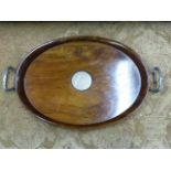 AN OVAL WALNUT SILVER MOUNTED TWO HANDLED ART DECO TRAY. APPROXIMATE MEASUREMENT 59.5cms x 37cms.