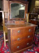 AN OAK ARTS AND CRAFTS DRESSING CHEST IN THE LIBERTY MANNER.