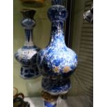 TWO ANTIQUE DELFT BLUE AND WHITE BOTTLE FORM VASES, ONE DECORATED WITH FIGURES IN THE CHINESE TASTE,