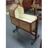 A 19th.C.MAHOGANY CHILD'S ROCKING CRADLE WITH CANEWORK SIDES AND HOOD.