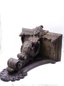 AN ANTIQUE LARGE CARVED OAK BAROQUE STYLE WALL BRACKET WITH CENTRAL MASK SUPPORTED BY FOLIATE