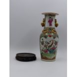 A CHINESE CANTONESE VASE WITH FOO LION HANDLES AND APPLIED SALAMANDERS TO THE SHOULDER. H.26cms.