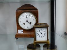 A BRASS CASED CARRIAGE CLOCK AND A WALNUT MANTLE CLOCK.