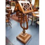 A VICTORIAN GOTHIC OAK DOUBLE SIDED READING STAND WITH LYRE SUPPORT. H.153cms.