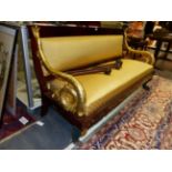 A CONTINENTAL MAHOGANY EMPIRE STYLE SETTEE WITH CARVED GILTWOOD SCROLLING DOLPHIN FORM ARMS AND