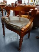 AN ANTIQUE FRENCH WALNUT TUB FORM ARMCHAIR WITH SCROLL ARMS AND RING TURNED TAPERED LEGS.