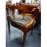 AN ANTIQUE FRENCH WALNUT TUB FORM ARMCHAIR WITH SCROLL ARMS AND RING TURNED TAPERED LEGS.