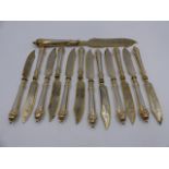 A SET OF TWELVE WHITE METAL FISH KNIVES AND A LARGER SERVING KNIFE WITH GILDED EDGES AND ENGRAVED