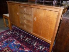 A GORDON RUSSELL OAK COTSWOLD SCHOOL SIDEBOARD WITH THREE CENTRAL DRAWERS. W.139cms.