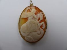 A CARVED CAMEO SCENE OF SAINT GEORGE AND THE DRAGON MOUNTED IN A STAMPED 9ct YELLOW GOLD BROOCH