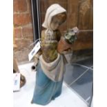 A LLADRO FIGURE OF A GIRL HOLDING A FLOWER POT. H.33cms.