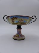 AN ANTIQUE AUSTRIAN ENAMELLED TWIN HANDLE TAZZA WITH FLARED PEDESTAL BASE, FINELY DECORATED WITH