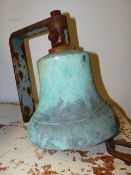 AN ANTIQUE BRONZE YARD BELL ON IRON HANGER. D.25cms.