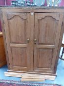 A VICTORIAN PINE KITCHEN CABINET WITH PANELLED DOORS. W.115 x H.147cms.