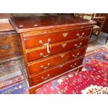 A MAHOGANY GEORGIAN STYLE SMALL CHEST WITH BRUSHING SLIDE, FOUR GRADUATED DRAWERS AND BRACKET FEET