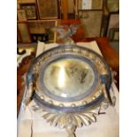 A REGENCY CARVED GILTWOOD CONVEX EAGLE CRESTED MIRROR WITH FLANKING CANDLE ARMS. H.87cms.