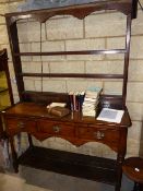 AN ANTIQUE AND LATER COUNTRY OAK POTBOARD DRESSER WITH THREE DRAWERS AND PLATE RACK OVER. W.137cms.