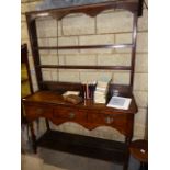 AN ANTIQUE AND LATER COUNTRY OAK POTBOARD DRESSER WITH THREE DRAWERS AND PLATE RACK OVER. W.137cms.