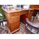 A VICTORIAN MAHOGANY INVERTED BREAKFRONT TWIN PEDESTAL DESK WITH MOULDED EDGE, THREE DRAWER TOP