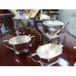 A SILVER PLATED ART DECO FOUR PIECE TEA SET AND A SMALL CADDY.