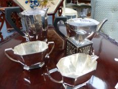 A SILVER PLATED ART DECO FOUR PIECE TEA SET AND A SMALL CADDY.