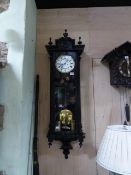 A VICTORIAN VIENNA WALL CLOCK WITH EBONISED CASE, UNSIGNED TWO PART ENAMEL DIAL COMPLETE WITH TWO