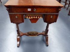 A VICTORIAN ROSEWOOD WORK TABLE WITH RISING TOP OVER TWO DRAWERS AND SEWING BASKET ON TRESTLE END