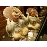 A PAIR OF VICTORIAN CONTINENTAL BISQUE ORIENTALIST STYLE NODDING HEAD SEATED FIGURES. H.17cms.