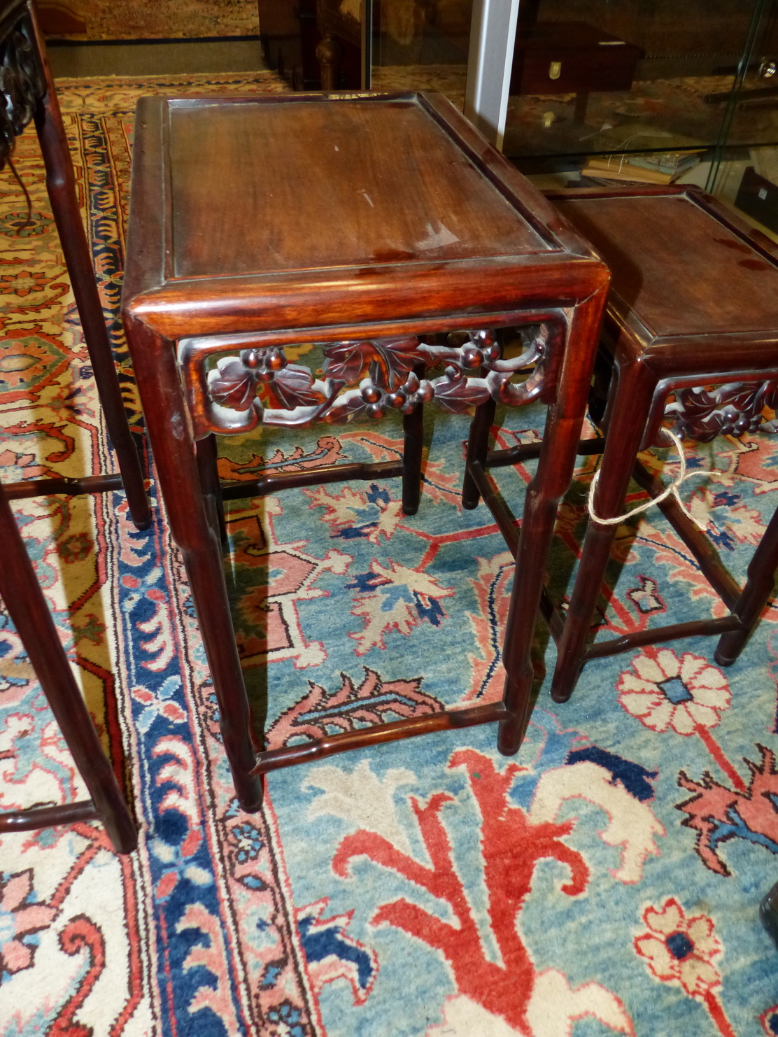 A NEST OF FOUR CHINESE CARVED HARDWOOD TABLES WITH PIERCED FOLIATE APRONS. - Image 5 of 19