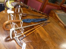 THREE ANTIQUE SILVER MOUNTED RIDING CROPS, ANOTHER BY SWAIN AND VARIOUS WALKING STICKS.