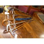 THREE ANTIQUE SILVER MOUNTED RIDING CROPS, ANOTHER BY SWAIN AND VARIOUS WALKING STICKS.