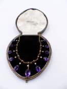 A PRECIOUS YELLOW METAL, TESTED AS GOLD, AMETHYST AND PEARL LAVALIER NECKLACE CONSISTING OF ELEVEN