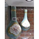 A PAIR OF VICTORIAN BOTTLE FORM COVERED VASES DECORATED WITH BIRDS AND GILDING IN THE FRENCH MANNER.