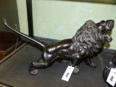 A JAPANESE BRONZE FIGURE OF A ROARING LION, SIGNED WITH SEAL TABLET TO BASE. L.51cms.