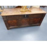 AN 18th.C.CARVED OAK AND INLAID PANEL PLANK TOP COFFER. W.141cms.
