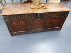 AN 18th.C.CARVED OAK AND INLAID PANEL PLANK TOP COFFER. W.141cms.