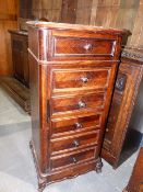 A FRENCH ROSEWOOD BEDSIDE CABINET WITH FOUR DRAWERS AND CHAMBER POT RECESS.