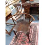A 19th.C.COUNTRY BEECH AND ELM COMB BACK ARMCHAIR WITH SHAPED CREST RAIL STANDING ON CABRIOLE