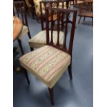 A SET OF SIX GEO.III.MAHOGANY DINING CHAIRS WITH SHAPED CARVED SLAT BACKS AND TAPERED FORELEGS.
