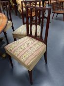 A SET OF SIX GEO.III.MAHOGANY DINING CHAIRS WITH SHAPED CARVED SLAT BACKS AND TAPERED FORELEGS.