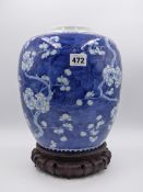 A CHINESE PRUNUS DECORATED BLUE AND WHITE GINGER JAR WITH CARVED HARDWOOD STAND, DOUBLE ENCIRCLED