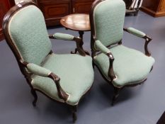 A PAIR OF FRENCH STYLE UPHOLSTERED ARMCHAIRS ON CABRIOLE LEGS.