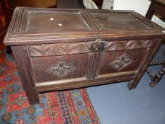 AN 18th.C.OAK TWO PANELLED COFFER WITH CARVED DECORATION. W.101cms.