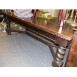 A SUSTANTIAL ANTIQUE OAK FLEMISH STYLE DINING/LIBRARY TABLE WITH BARLEY TWIST SUPPORTS AND SHAPED