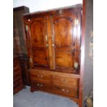 A LATE GEORGIAN COUNTRY OAK HANGING CUPBOARD WITH ARCHED AND INLAID PANEL DOORS OVER TWO FAUX AND