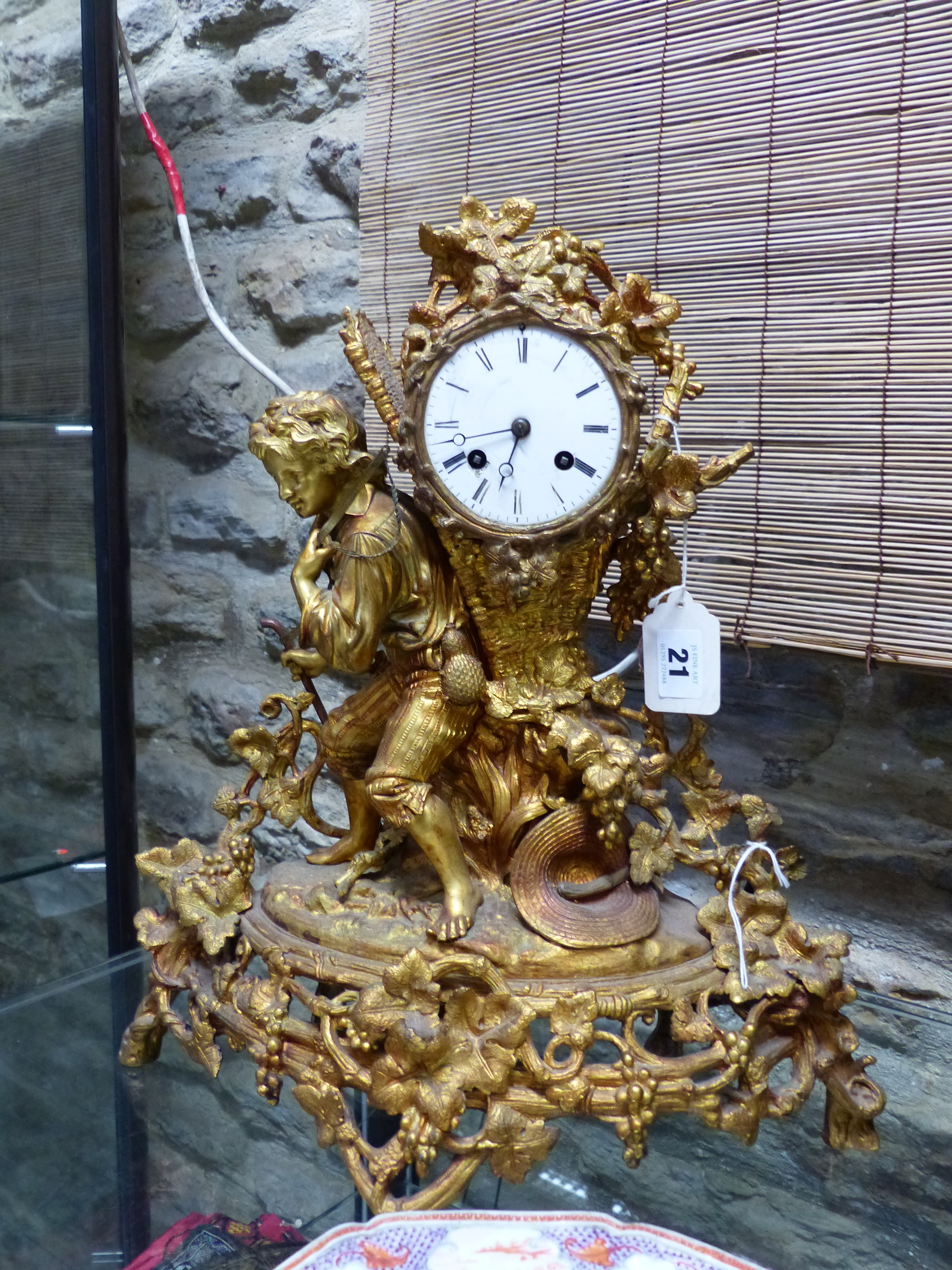 A 19th.C.GILT BRONZE MANTLE CLOCK, THE TWO TRAIN BELL STRIKE MOVEMENT WITH ENAMEL DIAL HOUSED WITHIN