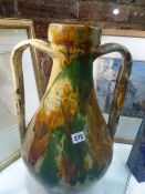 A LARGE CONTINENTAL SLIPWARE AMPHORA SHAPE TWIN HANDLED VASE. H.48cms.