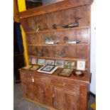 A 19th.C.IRISH KITCHEN DRESSER AND RACK WITH TWO DOOR AND TWO DRAWER BASE. W.143cms.
